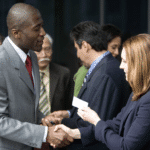 two business people exchanging business cards at networking event